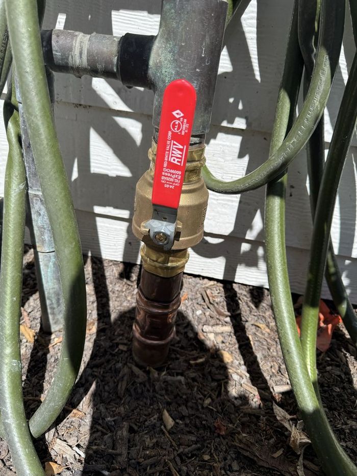 New brass shut-off valve installed for leak control
